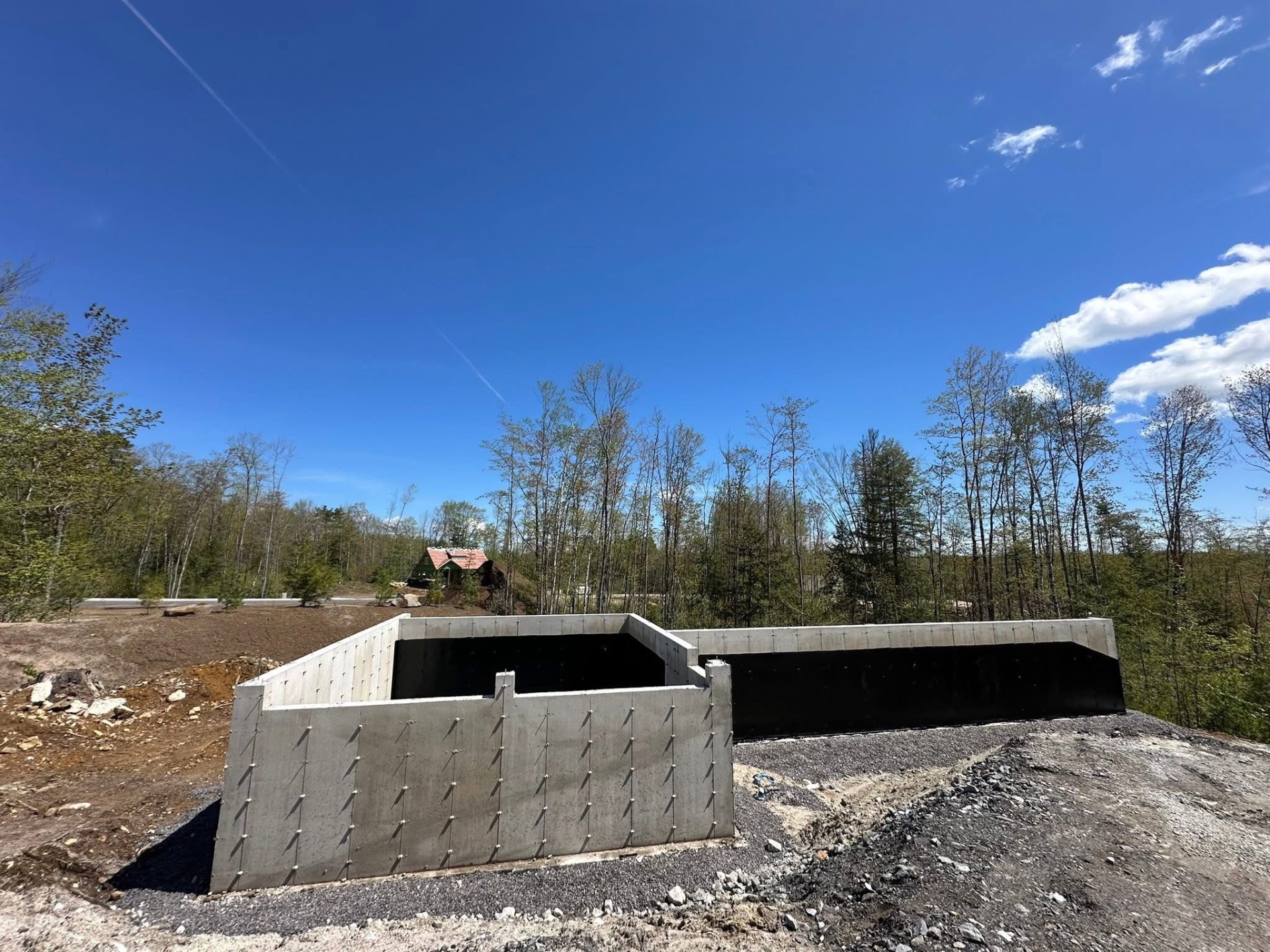 Stepped concrete foundation with snap tie pattern and waterproofing applied
