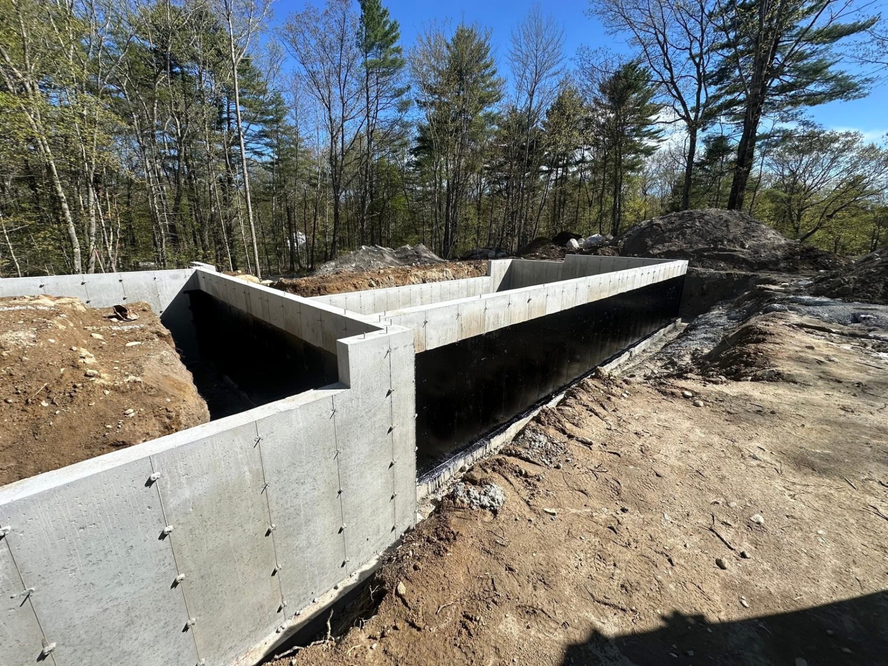 Interior view of poured concrete foundation with fresh sealant on exterior