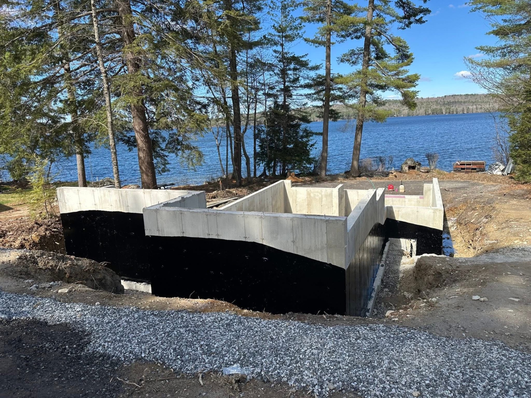 High-angle view of black waterproofing coating on foundation walls